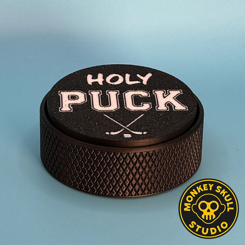 Black hockey puck fidget clicker with white text
