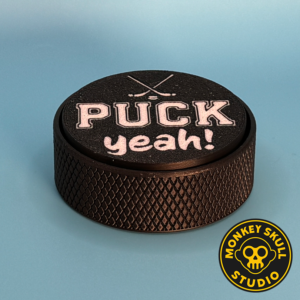 Black hockey puck fidget clicker with white text