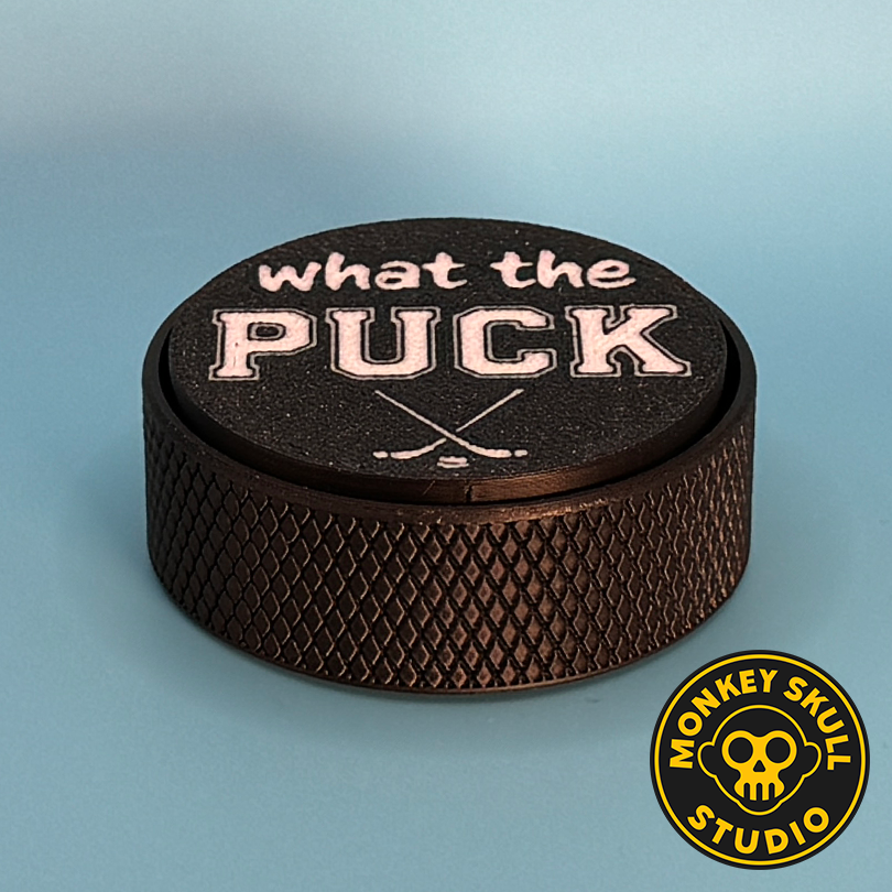 Black hockey puck fidget clicker with white text
